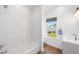 Bright bathroom features a shower-tub combo, white vanity, and a window offering natural light and views at 1002 Carmela Ct, North Charleston, SC 29405