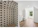 Bright bathroom featuring a modern shower with decorative star tiles, vanity, and hardwood flooring at 1002 Carmela Ct, North Charleston, SC 29405