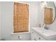 Bright bathroom featuring a modern vanity, sink, oval mirror, bamboo window shades and crisp, white walls at 1002 Carmela Ct, North Charleston, SC 29405
