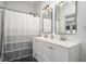 Bright bathroom featuring double sinks, modern fixtures, and a bathtub with a shower at 1002 Carmela Ct, North Charleston, SC 29405