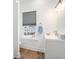 Bright bathroom features white cabinets, modern fixtures, and a window with neighborhood views at 1002 Carmela Ct, North Charleston, SC 29405