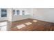 Sunlit bonus room with wood floors, multiple windows, and a fresh, neutral color palette at 1002 Carmela Ct, North Charleston, SC 29405