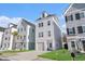Charming three-story home with a one car garage and a well-manicured lawn on a sunny day at 1002 Carmela Ct, North Charleston, SC 29405