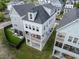 Stunning three-story home featuring a charming balcony, modern siding, and a well-maintained yard at 1002 Carmela Ct, North Charleston, SC 29405