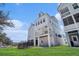 Multi-story home with white siding, a covered balcony, and well-maintained lawn at 1002 Carmela Ct, North Charleston, SC 29405