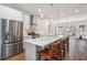 Modern kitchen boasts stainless steel appliances, a large island, and pendant lighting, ideal for cooking and socializing at 1002 Carmela Ct, North Charleston, SC 29405