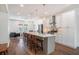 Modern kitchen features an island with seating, stainless steel appliances, and an open floor plan with a view to the living room at 1002 Carmela Ct, North Charleston, SC 29405