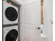 Modern, stacked washer and dryer set, featuring a bamboo window shade and neutral-colored walls at 1002 Carmela Ct, North Charleston, SC 29405