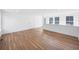 Bright and airy, this living room features beautiful wood flooring and large windows with plenty of natural light at 1002 Carmela Ct, North Charleston, SC 29405