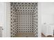 Close up of a stylish walk-in shower with unique star-patterned tiles and bronze fixtures at 1002 Carmela Ct, North Charleston, SC 29405
