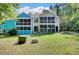 Expansive backyard showing both the blue and yellow units and attached screened-in porches at 105 Peacock Pl, Summerville, SC 29485