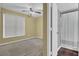 A neutral toned bedroom features a ceiling fan and a doorway to an attached bathroom at 105 Peacock Pl, Summerville, SC 29485
