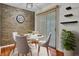 Cozy dining area with a stone accent wall and sliding glass door at 105 Peacock Pl, Summerville, SC 29485