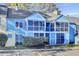 Brightly painted townhome featuring screened porches and lush landscaping at 105 Peacock Pl, Summerville, SC 29485