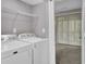 Functional laundry room equipped with washer and dryer and shelving at 105 Peacock Pl, Summerville, SC 29485
