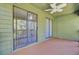 Covered porch has green painted wood siding with sliding glass doors and a ceiling fan at 105 Peacock Pl, Summerville, SC 29485