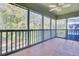 View of the screened porch with a ceiling fan overlooking a view of greenery at 105 Peacock Pl, Summerville, SC 29485