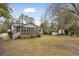 Backyard featuring a gray home with a screened-in porch and shed at 105 S Palmetto St, Summerville, SC 29483