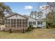 Charming home with a spacious screened-in porch and a well-maintained backyard at 105 S Palmetto St, Summerville, SC 29483
