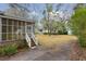 View of the side of home, screened-in porch, and backyard at 105 S Palmetto St, Summerville, SC 29483