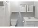 Bathroom featuring white fixtures including toilet, sink and shower with white shower curtain at 105 S Palmetto St, Summerville, SC 29483