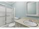 Bathroom with white vanity and shower with sliding glass doors at 105 S Palmetto St, Summerville, SC 29483