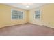 Bright bedroom with natural light through the two windows and beige carpet at 105 S Palmetto St, Summerville, SC 29483