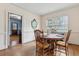 Bright dining room with hardwood floors and classic trim, with a view into another room at 105 S Palmetto St, Summerville, SC 29483