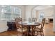 Bright dining room featuring hardwood floors, a round table, and ample natural light from large windows at 105 S Palmetto St, Summerville, SC 29483