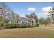 Charming house with a manicured front yard, brick chimney, and classic architectural details at 105 S Palmetto St, Summerville, SC 29483