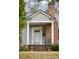 Charming front porch with brick accents, classic columns, and a hanging lantern at 105 S Palmetto St, Summerville, SC 29483