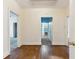 Hallway featuring hardwood floors and multiple doorways leading to different rooms at 105 S Palmetto St, Summerville, SC 29483