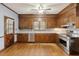 Traditional kitchen featuring wood cabinets, stainless steel appliances, hardwood floor and a view to the backyard at 105 S Palmetto St, Summerville, SC 29483