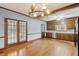 Spacious kitchen with wood cabinets, stainless steel appliances, tile countertops, hardwood floors and double doors at 105 S Palmetto St, Summerville, SC 29483