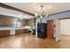 Spacious kitchen with wood cabinets, stainless steel appliances, tile countertops, and hardwood floors at 105 S Palmetto St, Summerville, SC 29483