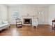 Spacious living room showcasing hardwood floors, a fireplace, and neutral decor creating a welcoming ambiance at 105 S Palmetto St, Summerville, SC 29483
