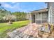Relax on the screened porch with views of the patio and fire pit in this spacious backyard at 105 Waylon Dr, Summerville, SC 29483