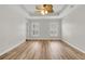 Spacious bedroom featuring tray ceiling, wood flooring, and plantation shutters at 105 Waylon Dr, Summerville, SC 29483