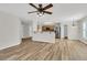 Open-concept living room flows into the kitchen, featuring wood floors and modern lighting at 105 Waylon Dr, Summerville, SC 29483