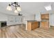 Open-concept living room featuring a fireplace, seamlessly flowing into the kitchen area at 105 Waylon Dr, Summerville, SC 29483