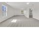 Bright living room features neutral paint, plush carpeting and natural light from large windows at 105 Waylon Dr, Summerville, SC 29483