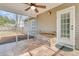 Covered and screened-in porch with tile flooring, ceiling fan and wood bench at 105 Waylon Dr, Summerville, SC 29483