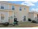View of the house's backyard featuring a small patio area and an air conditioning system at 113 Broad River Dr, Summerville, SC 29485