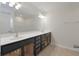 Bathroom featuring double vanity with black cabinets and large mirror at 113 Broad River Dr, Summerville, SC 29485