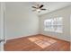 Bright bedroom features wood floors, a ceiling fan, and a large window for lots of natural light at 113 Broad River Dr, Summerville, SC 29485