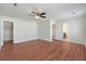 Bright bedroom featuring hardwood floors, a ceiling fan, and two entry doorways at 113 Broad River Dr, Summerville, SC 29485
