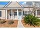 Charming single-story home featuring neutral siding, a covered porch with pillars and a walkway at 113 Broad River Dr, Summerville, SC 29485