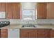 Well-lit kitchen featuring wooden cabinets, stainless steel sink, and modern appliances at 113 Broad River Dr, Summerville, SC 29485