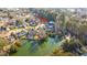 Aerial view of house and the community showing landscaping, neighboring houses and pond in the neighborhood at 1253 Lakefront Dr, Charleston, SC 29412