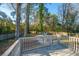 Backyard wooden deck overlooking peaceful outdoor space with mature trees and privacy fence at 1253 Lakefront Dr, Charleston, SC 29412